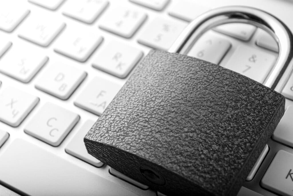 Padlock lying on a white keyboard 