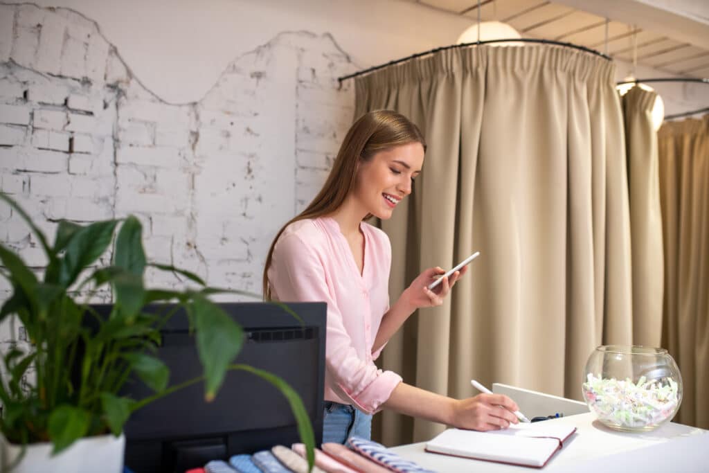 Office manager writing down an appointment for a client.