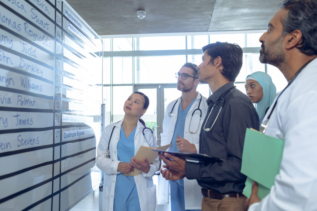 Group of doctors looking at their schedule chart